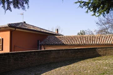 A walkway in a medieval village with roof tiles in background (Marche, Italy, Europe)