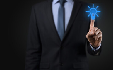 Businessman in a suit with a light bulb in his hands. Holds a glowing idea icon in his hand. With a place for text