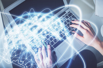 Double exposure of woman hands working on computer and financial theme hologram drawing. Top View. Business concept.