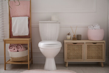 Fototapeta na wymiar Stylish bathroom interior with toilet bowl and other essentials