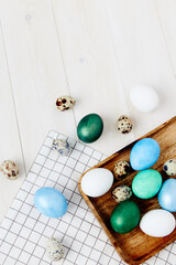 colorful eggs on chalkboard wooden background top view Easter holiday