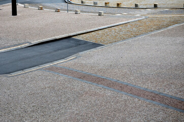 stone paving of squares and streets of various formats and sizes and colors of cubes. folding in...