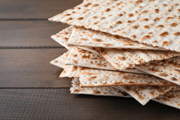 Stack of matzos on wooden table, closeup