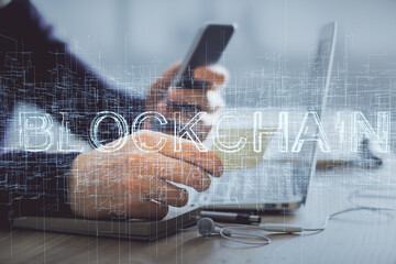 Double exposure of man's hands holding and using a phone and crypto currency blockchain theme drawing.