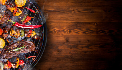 Top view of fresh meat and vegetable on grill