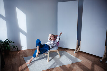 girl in jeans and shirt lying on a chair, minimalistic design