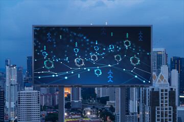 Information flow hologram on road billboard, night panorama city view of Kuala Lumpur. KL is the largest technological center in Malaysia, Asia. The concept of programming science.