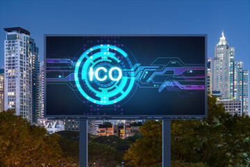 ICO hologram icon on billboard over panorama city view of Bangkok at night time. The hub of...