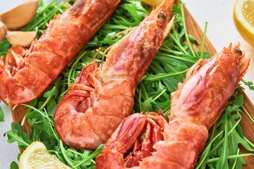 Red raw prawns, close up. Fresh shrimps with lemon and rucola. Seafood background
