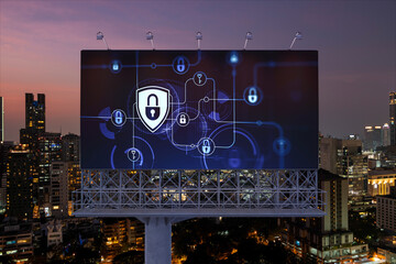 Padlock icon hologram on road billboard over panorama city view of Bangkok at night to protect business, Southeast Asia. The concept of information security shields.