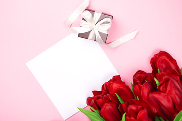 Fototapeta premium Greeting Card mockup beautiful tulips and place for text. Flat lay template with copy space. Photography for design.
