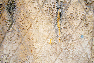 texture of a yellow wall covered with volumetric plaster, space for text, space for copy