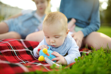 Cute five months old baby boy lying on his tummy. Baby playing with a toy during tummy time.