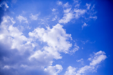 Naklejka na ściany i meble Blue sky with black clouds. Background texture.