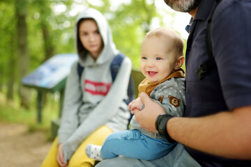 Fototapeta premium Family of three exploring the Dubingiai Castle Hill, former island, now a peninsula, located by Lake Asveja, the longest lake in Lithuania.