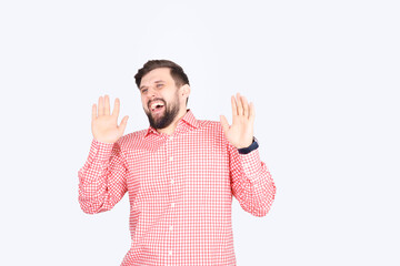 Fototapeta premium A bearded man in a pink checked shirt laughs. Young unshaven guy funny