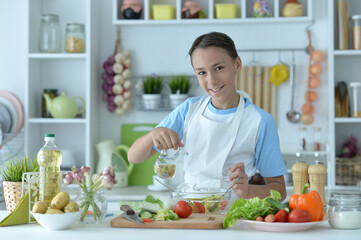Cute boy preparing  cooking  at home
