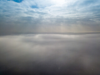 Obraz premium Aerial high view. Flying over the clouds.