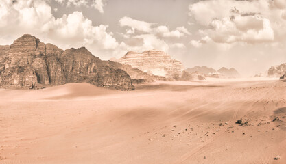 Fototapeta na wymiar Panorama of the Wadi Rum desert in Jordan with retro or vintage faded monochrome mood