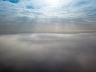 Fototapeta na wymiar Aerial high view. Flying over the clouds.