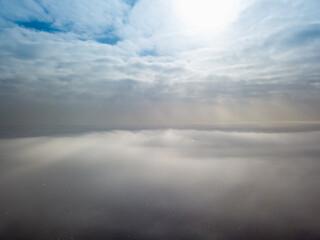 Obraz premium Aerial high view. Flying over the clouds.