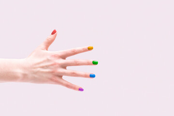 LGBT style manicure. Multi-colored nail polish on female hands.