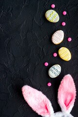 Obraz na płótnie Canvas Happy Easter background. Bunny ears with eggs cookies, space for text