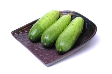  Fresh cucumber and slices on white background.