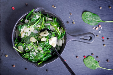 spinach with garlic in a cast iron pan