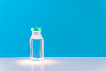 Potential trials stage concept on blue background. Close up Vials with sterile needle syringe. Research and Development, Vaccination.