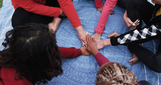 Multiracial people stacking hands - Concept of multi generational women and unity