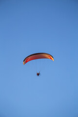 paraglider flying with paramotor on sunset