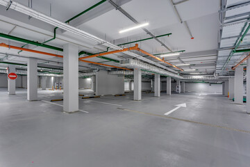 empty underground garage parking with columns and road markings