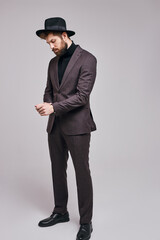 Obraz na płótnie Canvas businessman in suit button up cufflinks isolated in studio