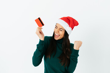 Christmas shopping, brunette young woman wearing red santa hat