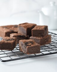 Homemade fudgy chocolate brownies on white background.