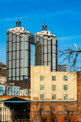 Two skyscrapers buildings stand in autumn on a sunny day / apartments in vladivostok city