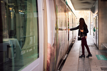 woman opening the door to board the streetcar