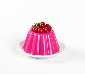 Creamy beet Panna Cotta with cranberries on a plate on a white background