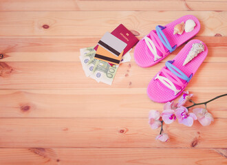 Set of things for summer holidays and branch of orchid on wooden background