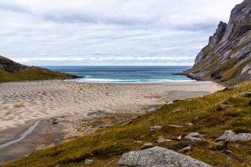 Top View of Bunes beach, free of tourists, on a cold spring day. No People at Bunes Beach. Famous tourist hotspot or destination. Deep blue water and mountains at Bunes Beach, Lofoten Island, Norway