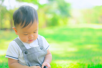 Portrait of a happy little boy in the park,Little boy in grass field