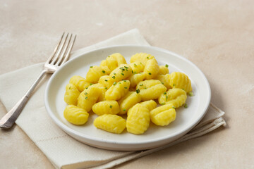 Potato dumplings gnocchi mediterranian food. Cooked gnocchi with butter and green onions.
