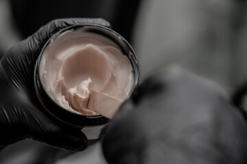 Close-up photo of tattoo cream healing in salon. Concept of tattoo artist salon workshop.