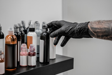 Close-up of tattoo artist work place parts and paint. Professional tattooist working tattooing in studio