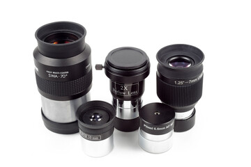 Telescope eyepieces and barlow lens on white background, isolate, close-up.