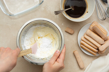 Mixing, whipping cream for cake. Cooking tiramisu cake with sponge fingers cookies. Step by step recipe.