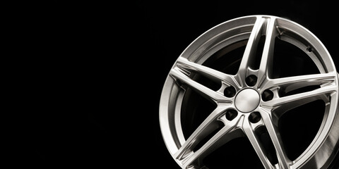 alloy wheel, sporty alloy, in the shape of a star on a dark background. empty space Copyspace