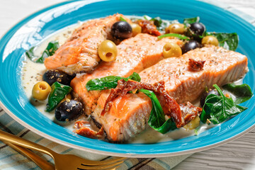 Salmon stew with cream sauce on a plate, top view