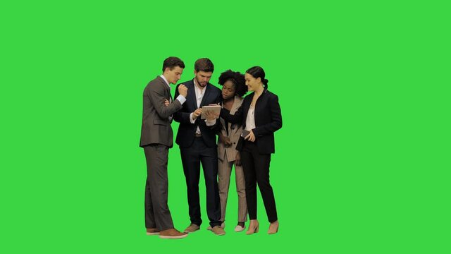 Business colleagues discussing some project on their tab on a Green Screen, Chroma Key.